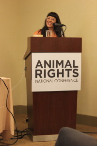 Isha speaking at a podium