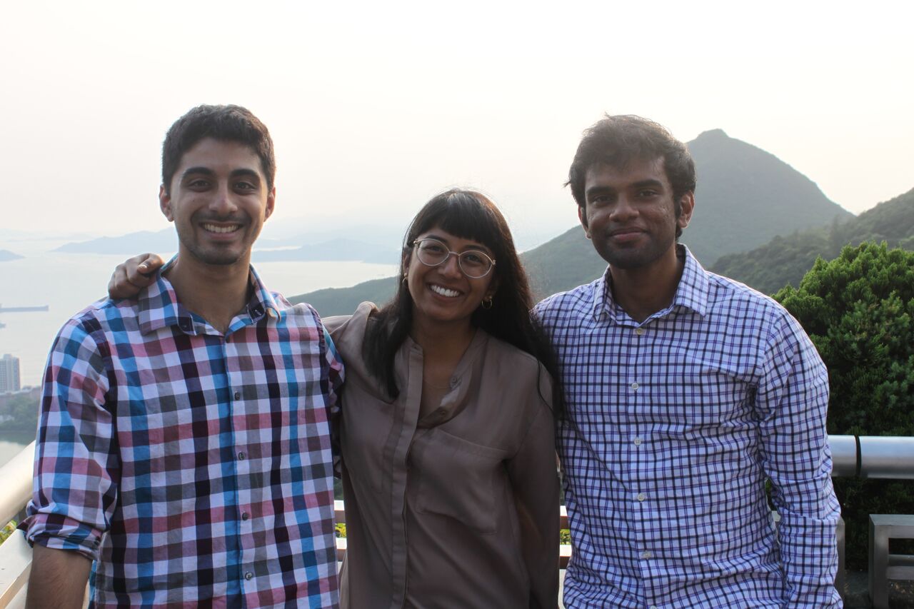 Ryan, Isha, and Perumal standing with eachother in Hong Kong