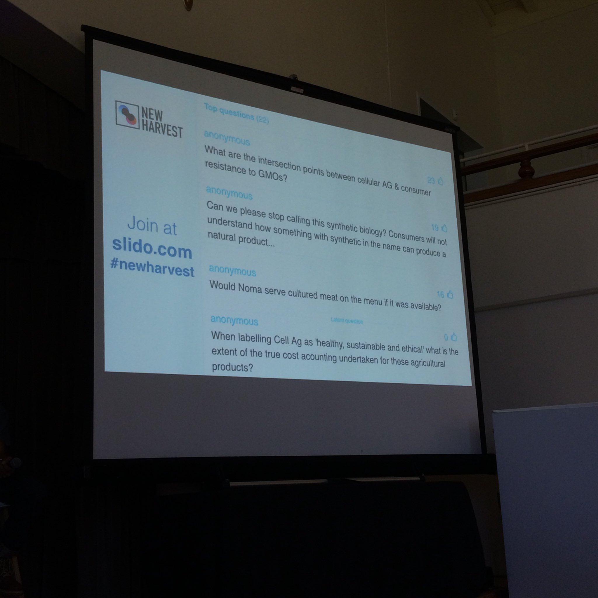 slide with slido question. Whestions shown are "What are the intersection points between cellular agriculture and consumer resistance to GMO'S?' 'Can we please stop calling this synthetic biology? Consumers will not understand how something with synthetic in the name can be a natrual product?' ' Would Noma serve cultured meat if it was available?' 'When labeling Cell Ag as 'healthy, sustainable, and ethical' what is the extent of the tru cost accounting undertaken for these agricultural products?'