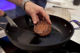 Photo of the cultured meat patty being cooked on a frying pan